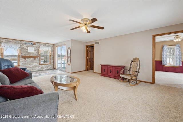 carpeted living room featuring ceiling fan