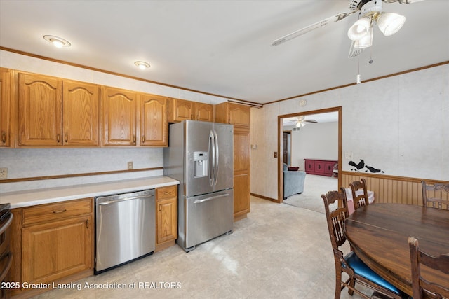 kitchen featuring crown molding, ceiling fan, and appliances with stainless steel finishes