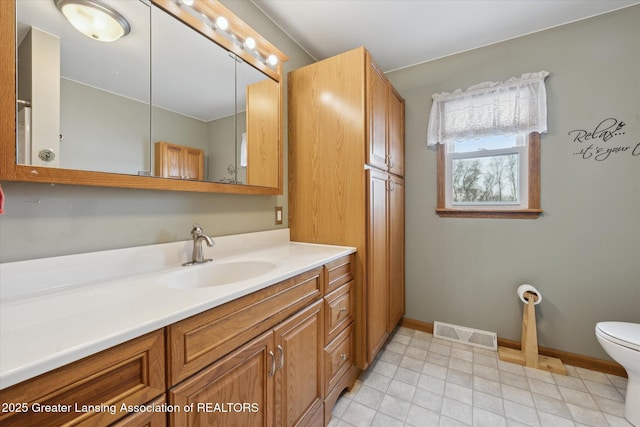 bathroom featuring vanity and toilet