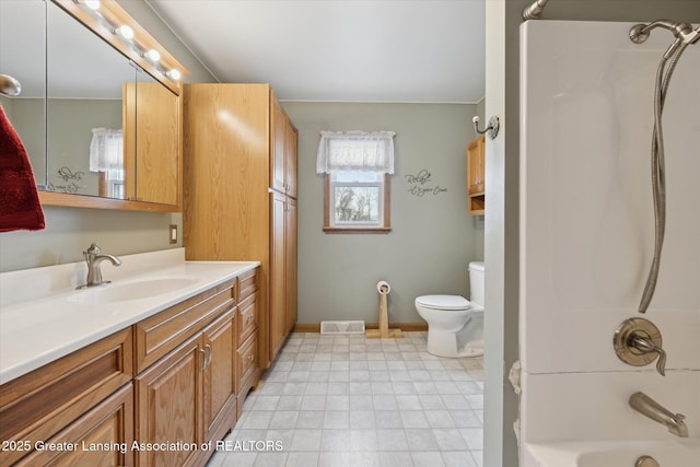 full bathroom featuring vanity, toilet, and washtub / shower combination