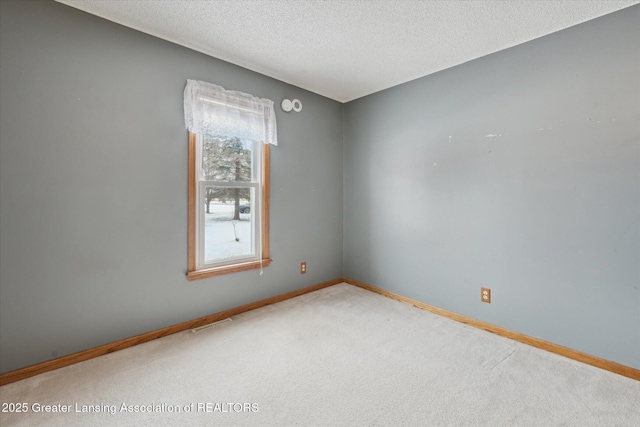 empty room with carpet and a textured ceiling