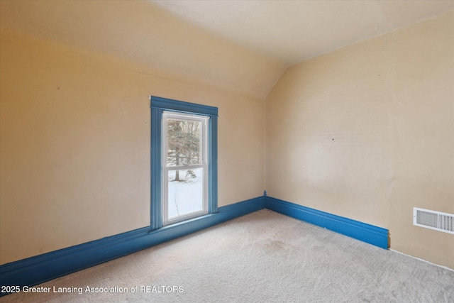 unfurnished room with lofted ceiling and carpet