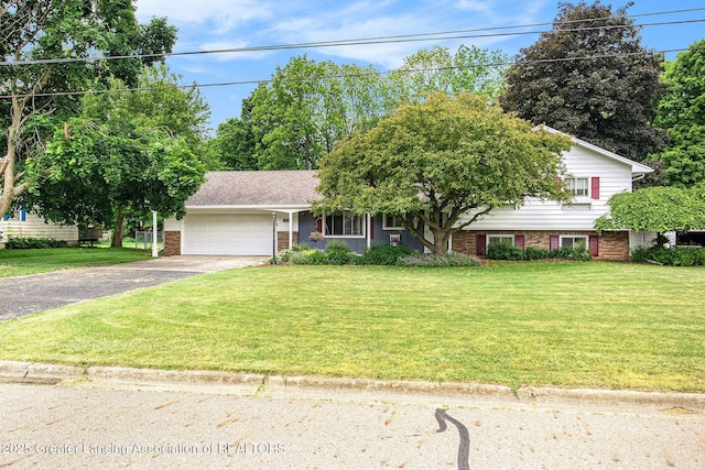 view of front of property with a garage and a front yard