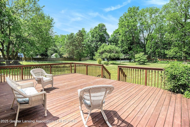 wooden deck with a lawn