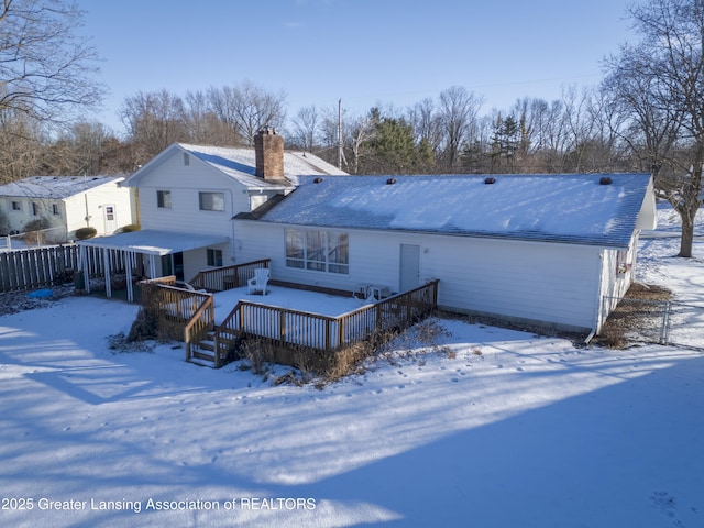 snow covered property featuring a wooden deck