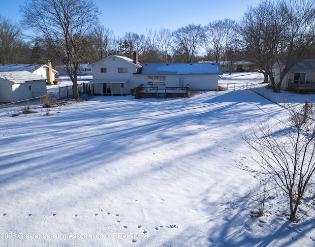 snowy yard with a deck