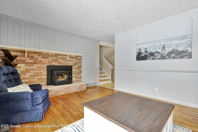 living room featuring wood-type flooring and a textured ceiling