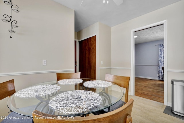 dining area featuring ceiling fan and light hardwood / wood-style flooring