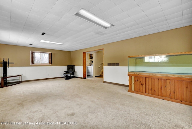 interior space with light carpet and washer / clothes dryer