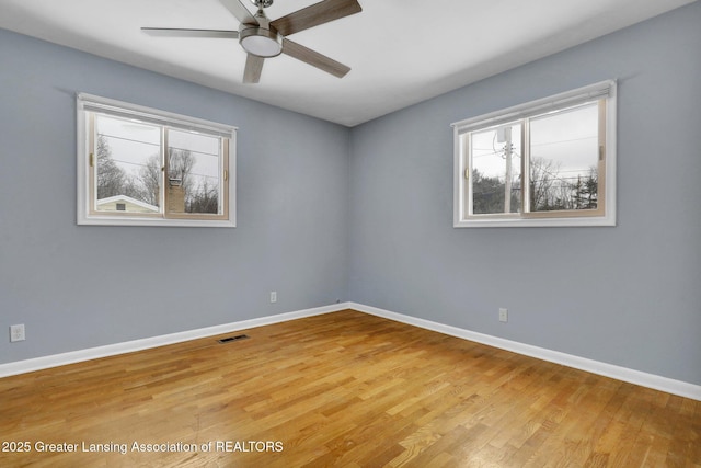 empty room with ceiling fan and light wood-type flooring