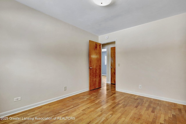 unfurnished room with light wood-type flooring