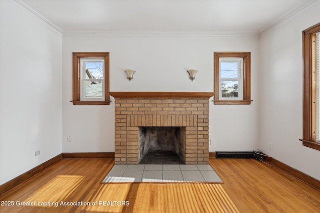 unfurnished living room with crown molding, a fireplace, and light hardwood / wood-style flooring