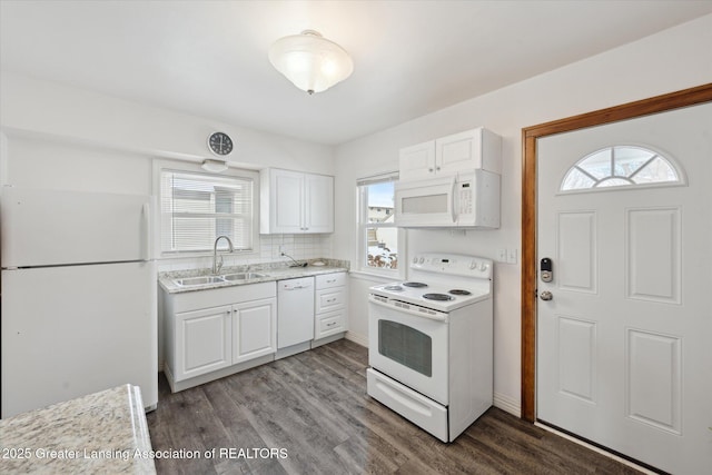 kitchen with white cabinetry, dark hardwood / wood-style flooring, sink, and white appliances