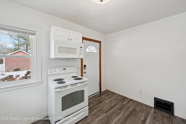 kitchen with white cabinetry, dark hardwood / wood-style floors, a wealth of natural light, and white appliances