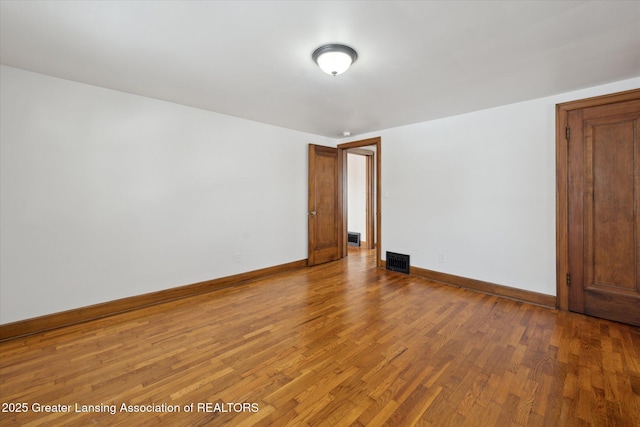 empty room with wood-type flooring