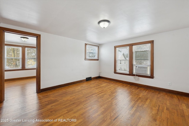 unfurnished room featuring hardwood / wood-style flooring and cooling unit