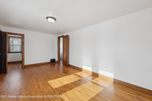 empty room with hardwood / wood-style floors