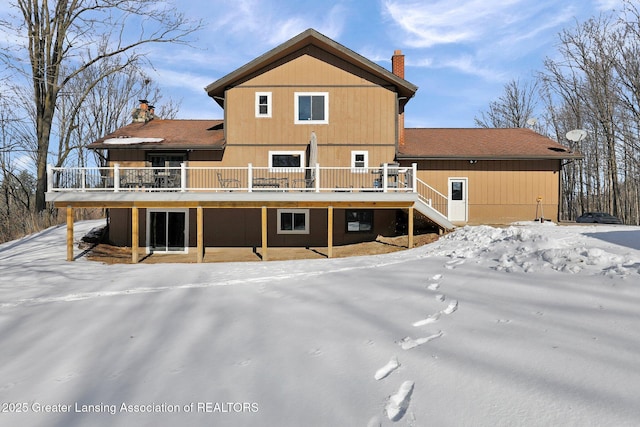 snow covered property featuring a wooden deck