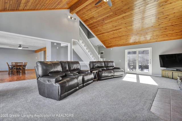 carpeted living room featuring beam ceiling, high vaulted ceiling, wood ceiling, and ceiling fan