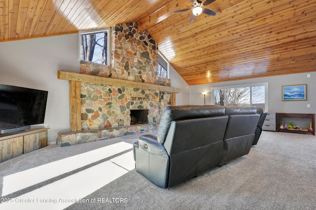 living room with carpet, a stone fireplace, and wood ceiling