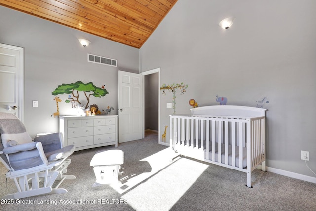 carpeted bedroom with wood ceiling, high vaulted ceiling, and a nursery area