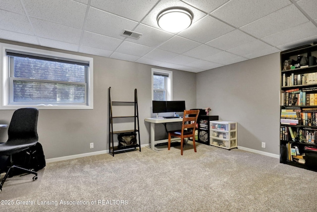 office area with a paneled ceiling and light carpet