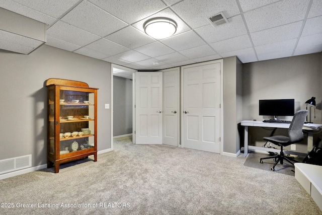 office space with light carpet and a drop ceiling