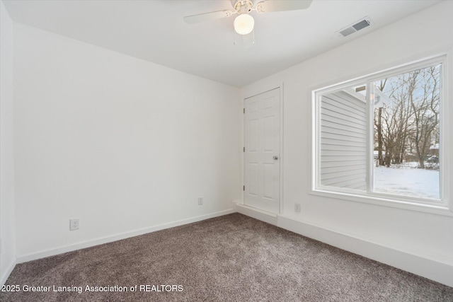 carpeted empty room featuring ceiling fan