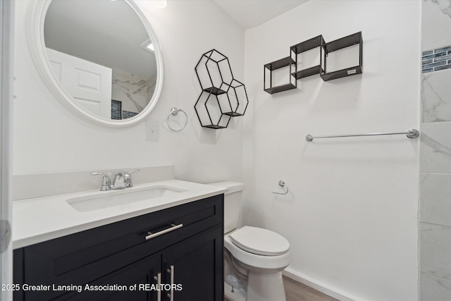 bathroom featuring vanity, hardwood / wood-style floors, and toilet