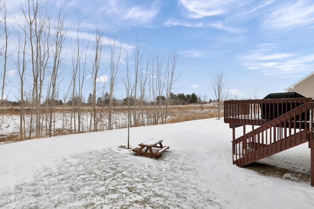 yard layered in snow featuring a wooden deck