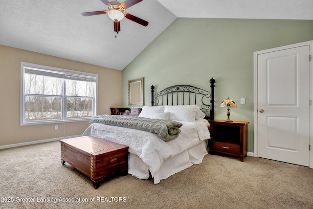 bedroom with ceiling fan, vaulted ceiling, and light carpet