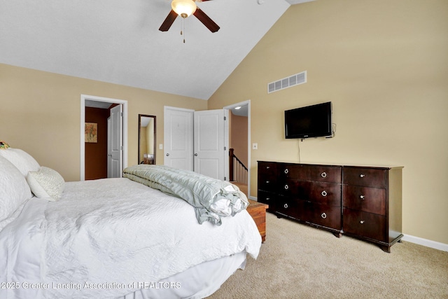 bedroom featuring light carpet, high vaulted ceiling, and ceiling fan