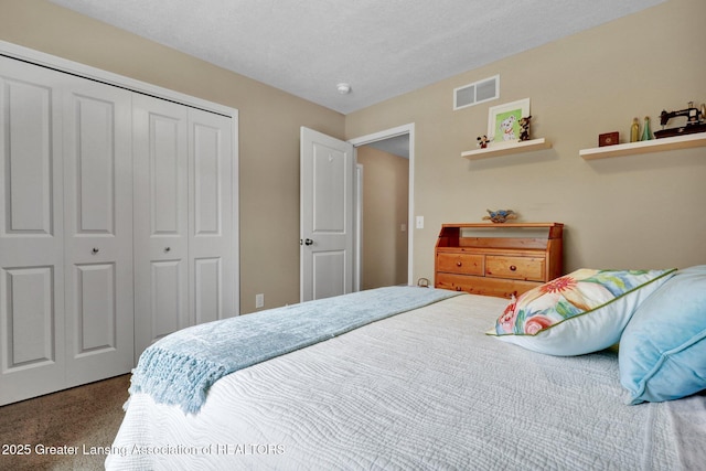 bedroom with a closet and a textured ceiling