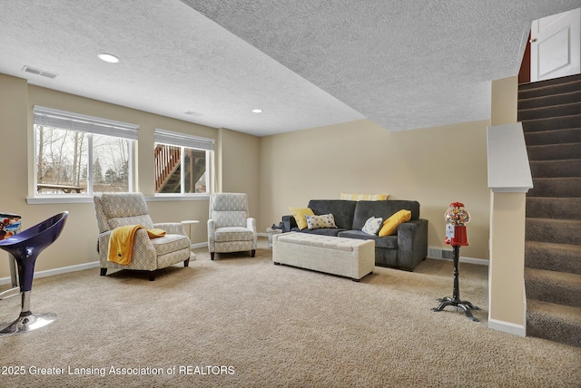 carpeted living room featuring a textured ceiling