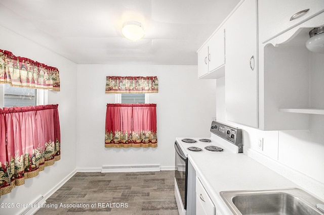 kitchen featuring white cabinetry, dark hardwood / wood-style flooring, range with electric cooktop, and baseboard heating