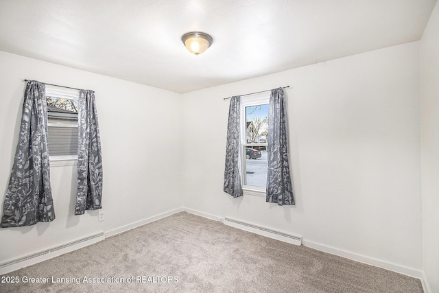 empty room featuring a baseboard radiator and carpet