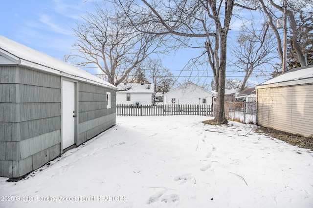 snowy yard with an outdoor structure