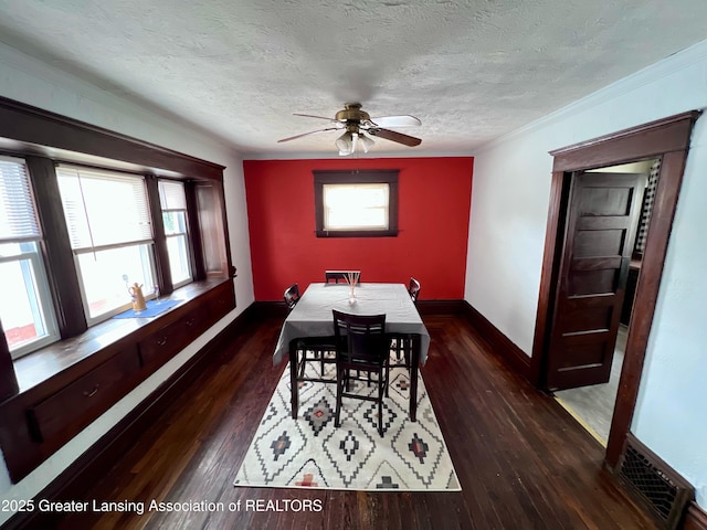 dining room featuring ceiling fan, ornamental molding, dark hardwood / wood-style floors, and a textured ceiling