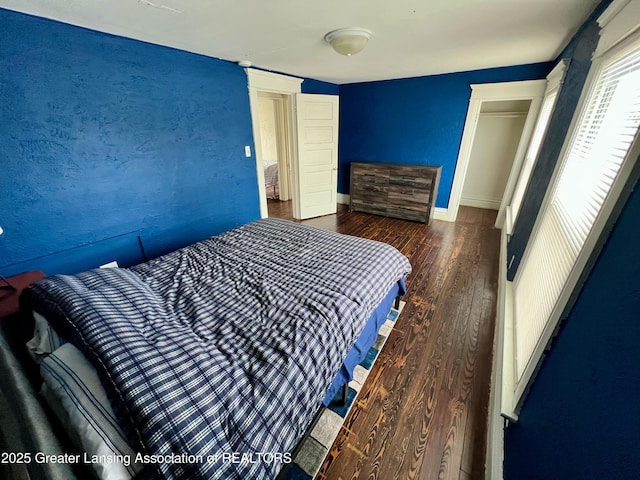 bedroom with dark hardwood / wood-style floors