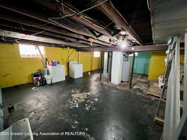 basement featuring washing machine and dryer and gas water heater