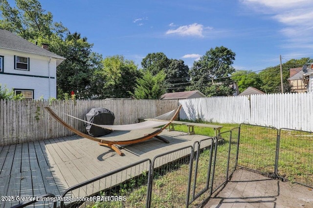 wooden deck featuring a lawn