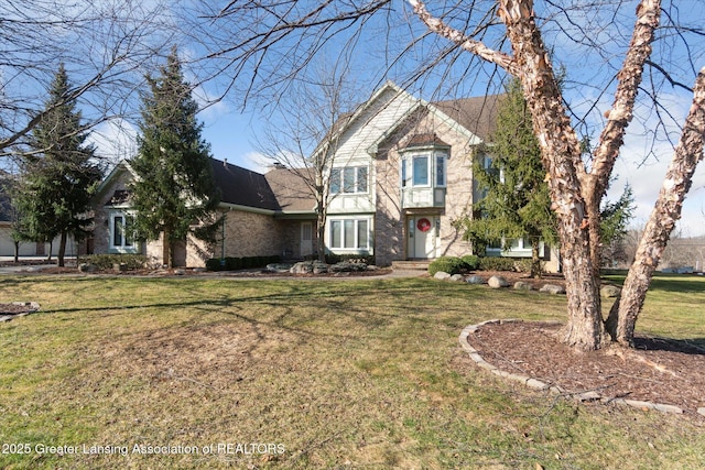 view of front facade with a front yard and roof with shingles