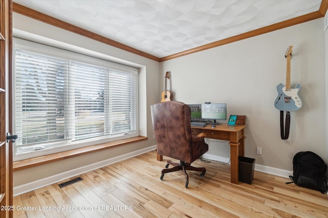 office with crown molding, wood finished floors, visible vents, and baseboards