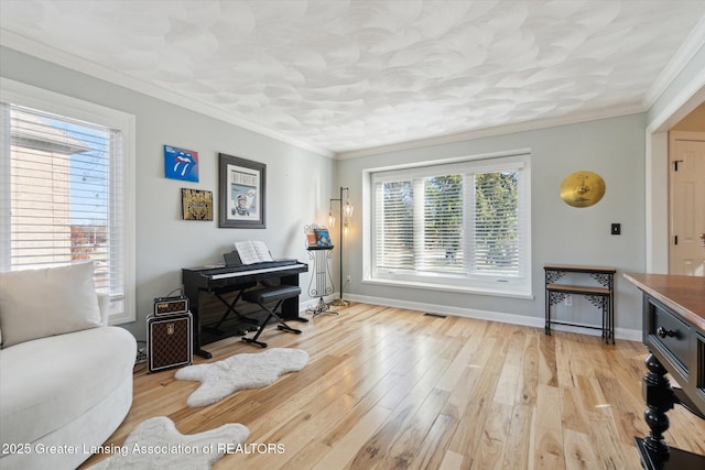 office space with light wood finished floors, baseboards, and ornamental molding