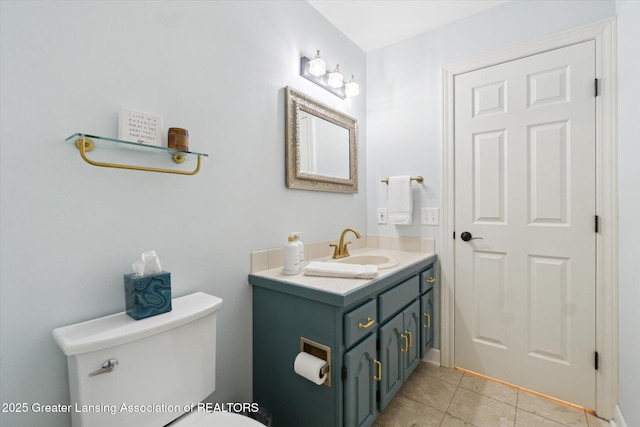 half bathroom with tile patterned flooring, toilet, and vanity