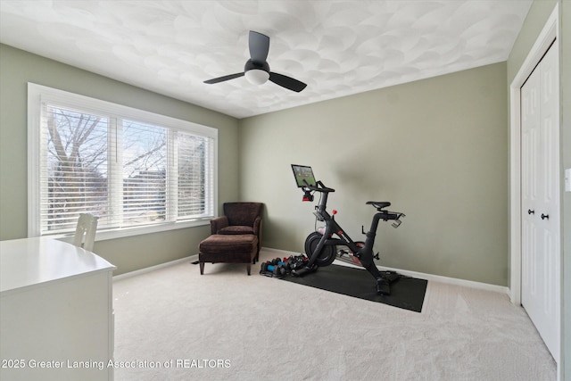 workout room with carpet, baseboards, and ceiling fan