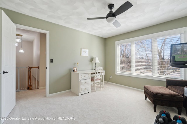 office featuring carpet flooring, a ceiling fan, and baseboards