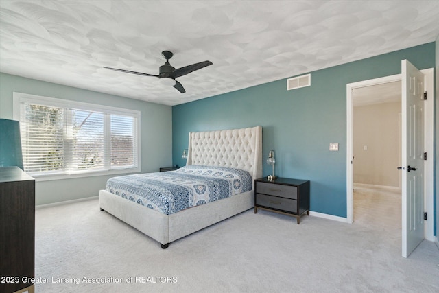 carpeted bedroom with baseboards, visible vents, and ceiling fan