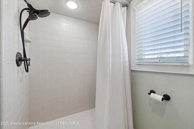 full bath featuring tiled shower