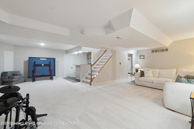 living room featuring stairway, visible vents, and carpet floors